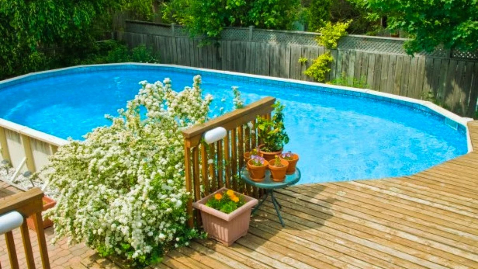 A wooden deck featuring a pool surrounded by a wooden fence, creating a serene outdoor space.