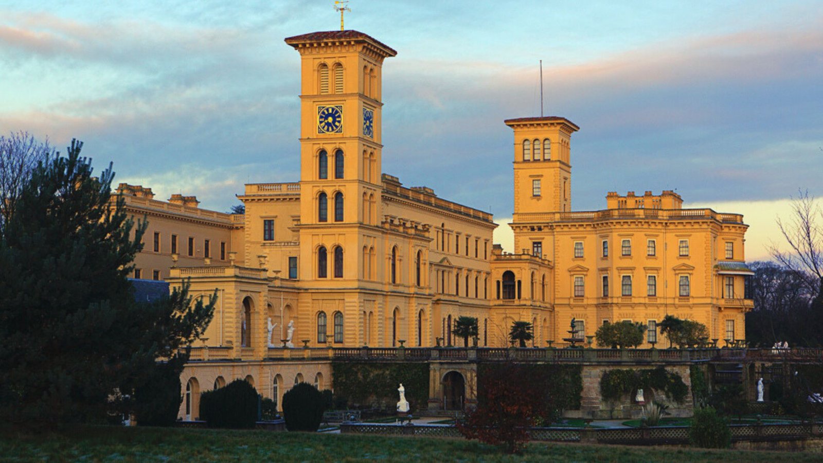 A large building featuring two prominent towers and a clock at the top, showcasing an impressive architectural design.