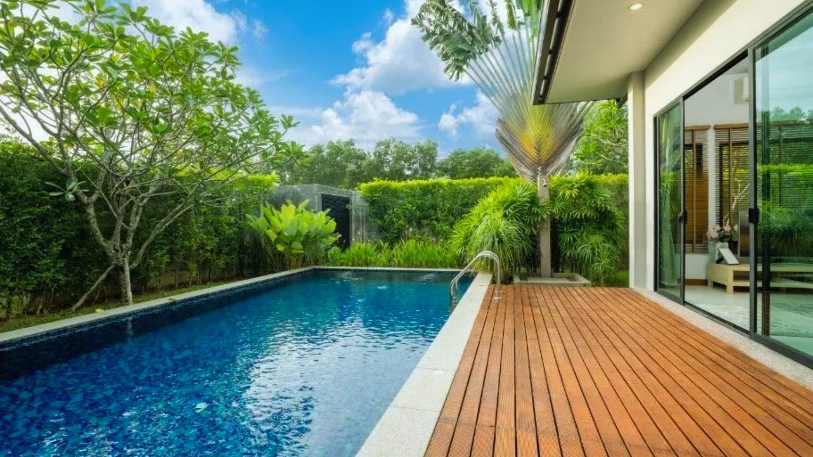 Interior view of a contemporary home showcasing a pool with elegant wooden flooring.