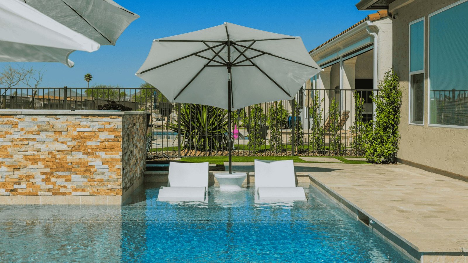A serene pool surrounded by a spacious patio, ideal for relaxation and outdoor gatherings.