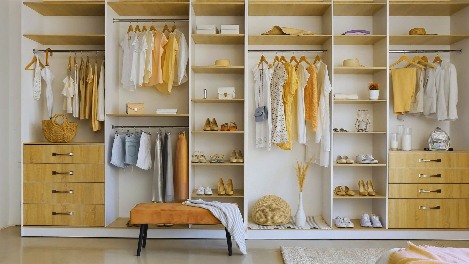 A closet filled with neatly arranged yellow and white clothing items, showcasing a bright and cheerful color palette.