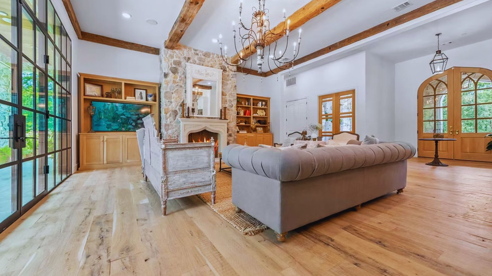 A cozy living room featuring a fireplace and warm wood floors, creating an inviting atmosphere for relaxation.