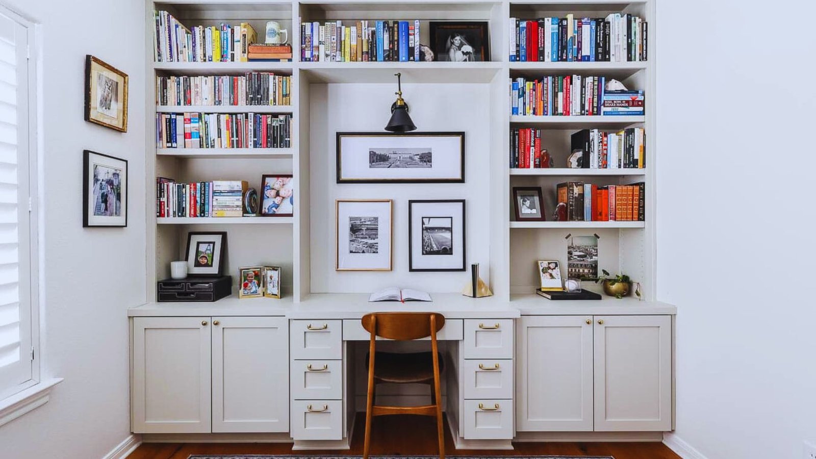 A home office featuring a desk and bookshelves filled with books, creating a cozy and organized workspace.