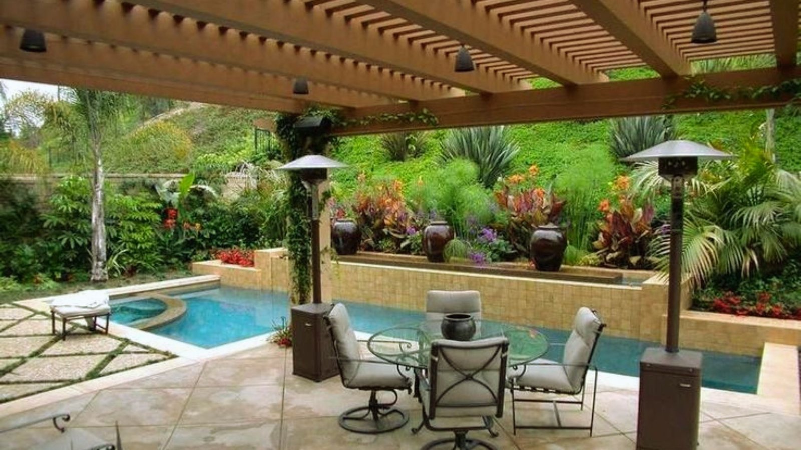 A patio featuring a swimming pool surrounded by outdoor furniture for relaxation and leisure.