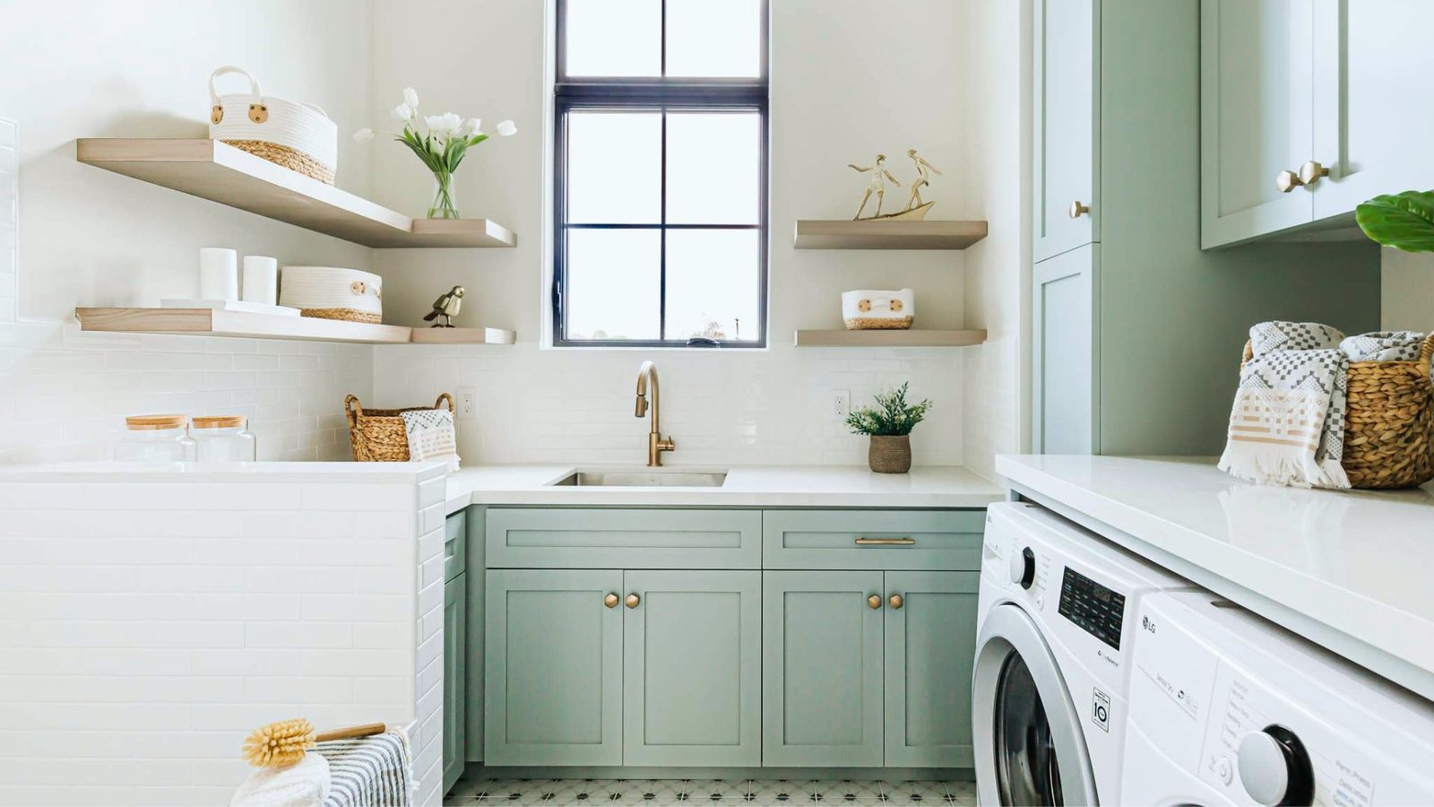  A laundry room featuring a washer and dryer, with shelves and laundry supplies visible in the background.