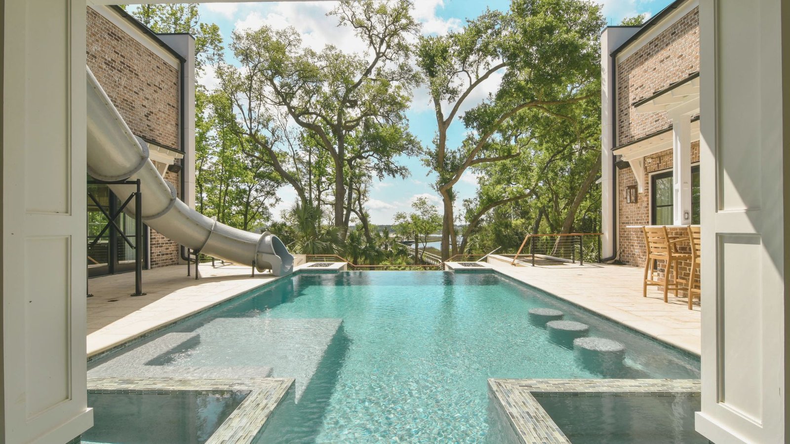 A swimming pool featuring a slide positioned in the center, inviting for recreational use.