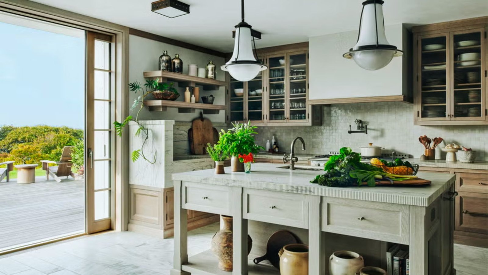 A spacious kitchen with a large window and a sink, creating a welcoming and well-lit cooking area.