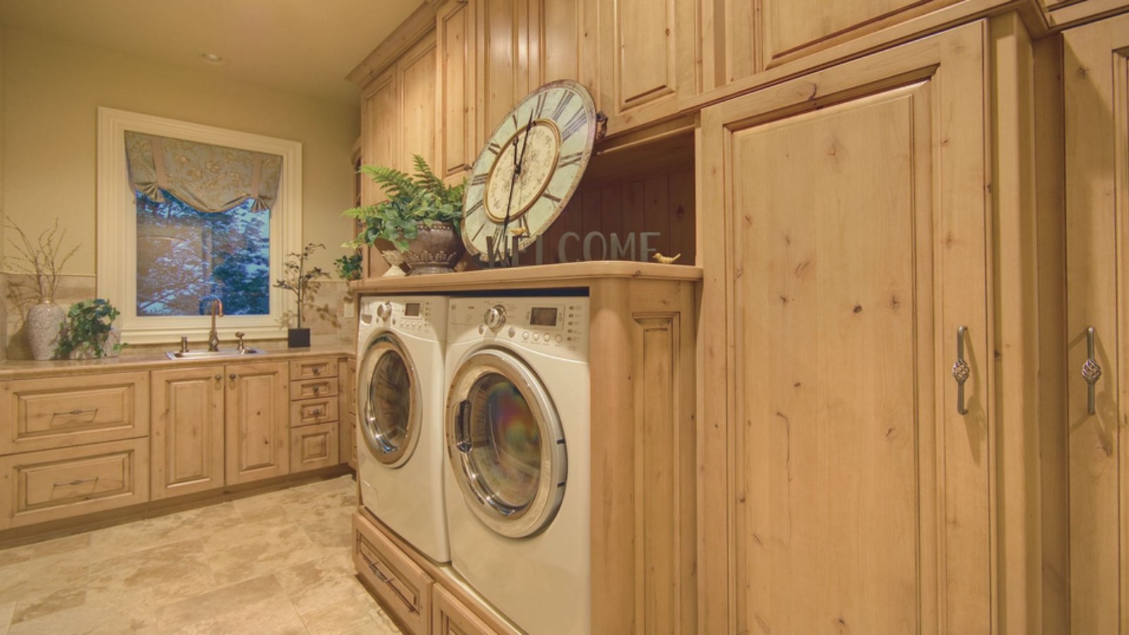 A spacious laundry room featuring a washer and dryer, with ample space for sorting and folding clothes.