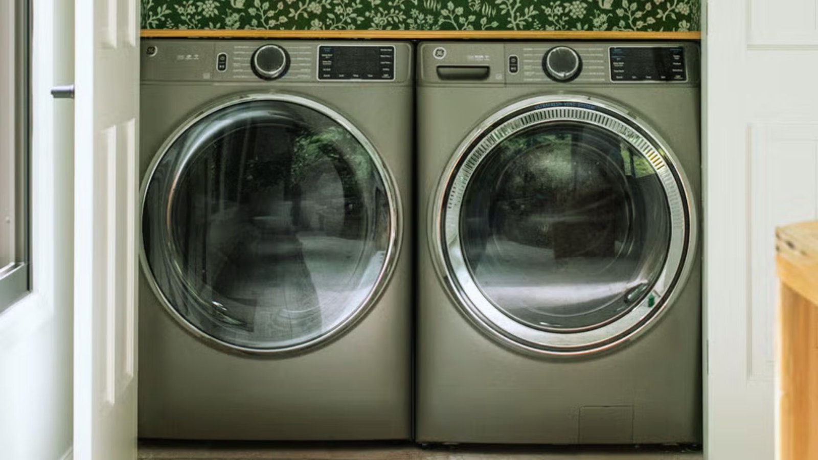 A compact laundry room featuring a stacked washer and dryer against a light-colored wall.