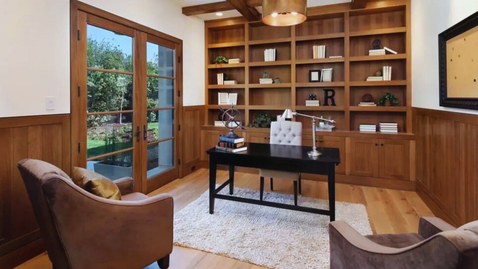 A home office featuring a desk and bookshelves filled with books, creating a cozy and organized workspace.