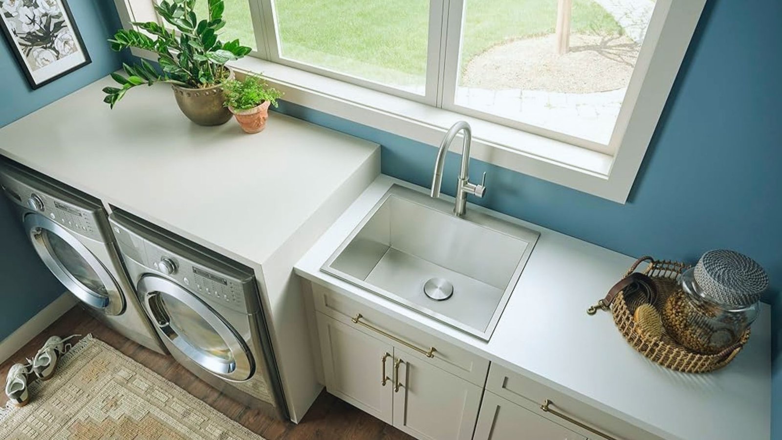 A laundry room featuring a sink and a washing machine, with clean, organized space for laundry tasks.
