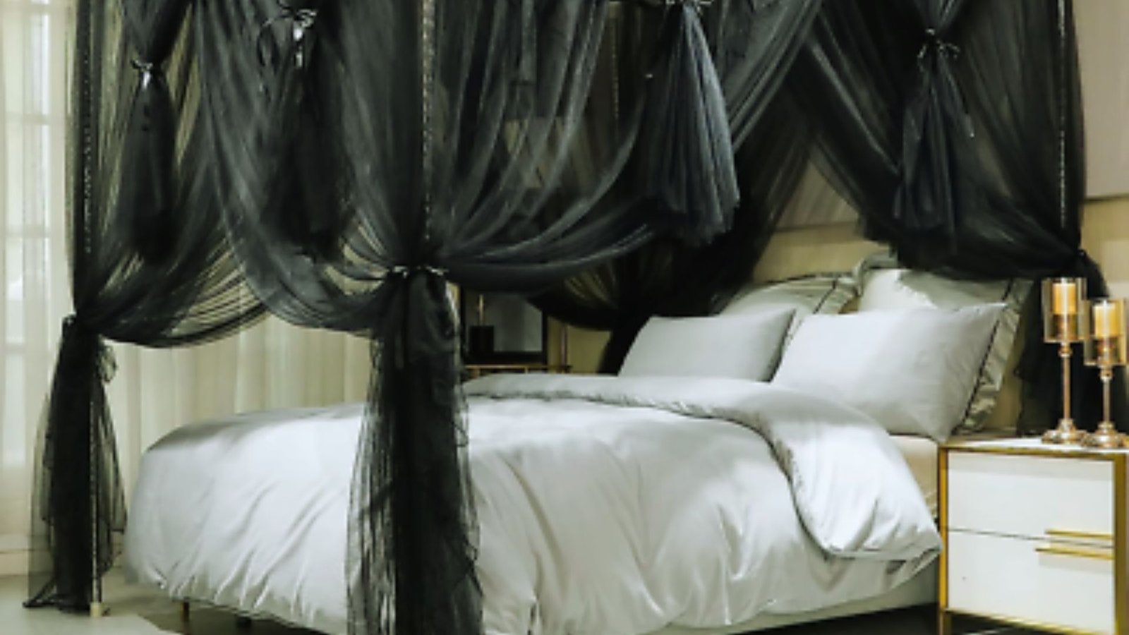 A black canopy bed adorned with crisp white sheets and pillows, creating a stylish and elegant bedroom setting.