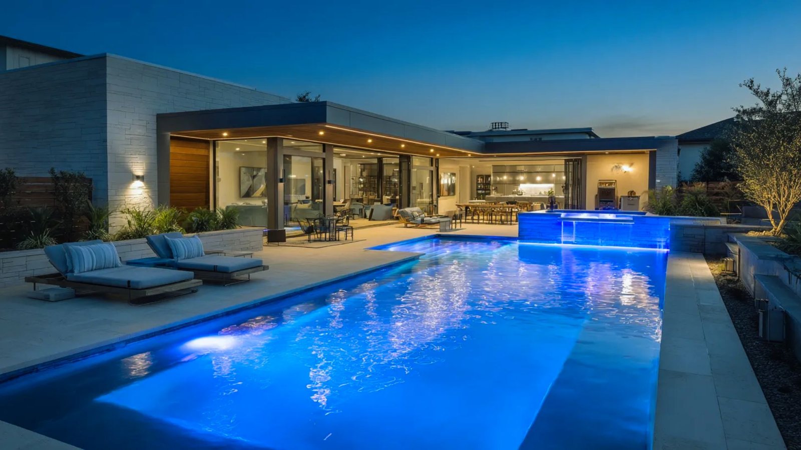 A contemporary home featuring a swimming pool and an inviting patio area for outdoor relaxation.