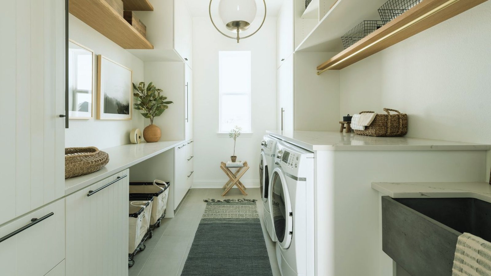 A laundry room featuring a sink, washer, and dryer, organized and ready for household laundry tasks.