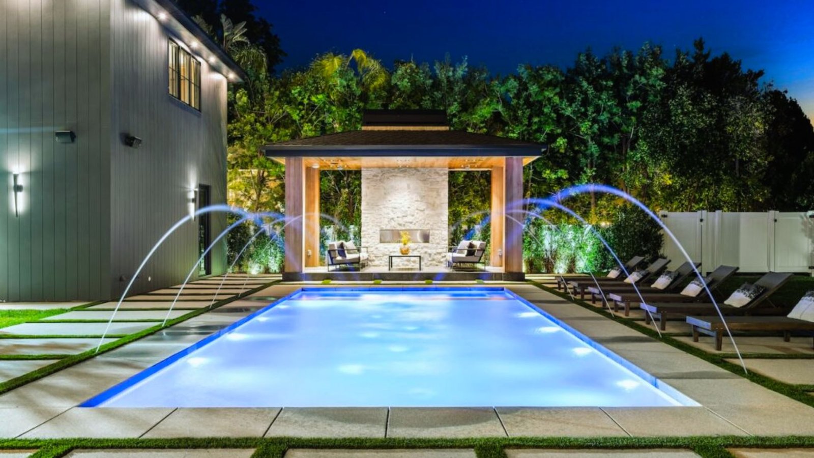 A serene pool featuring water features and a comfortable lounge area for relaxation.