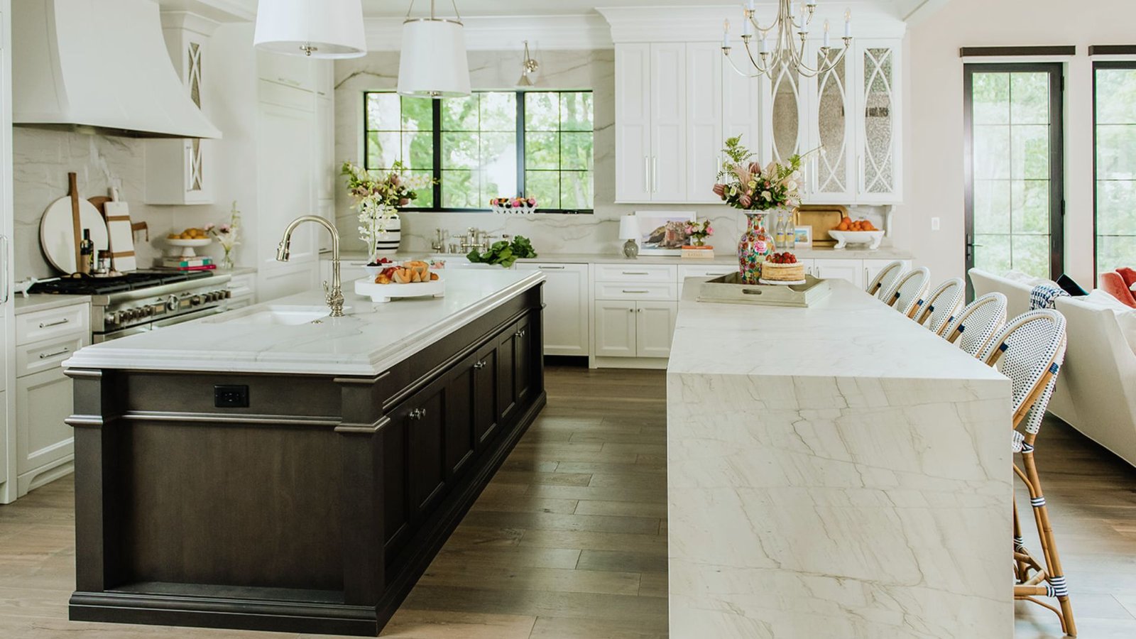 A stylish kitchen with sleek white cabinetry and luxurious marble countertops.