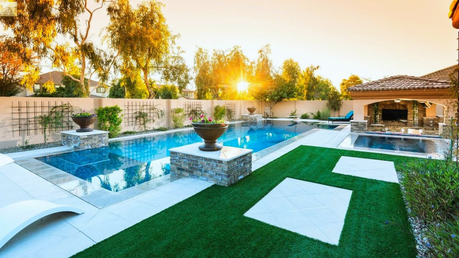 A backyard featuring a swimming pool surrounded by a well-maintained lawn area.