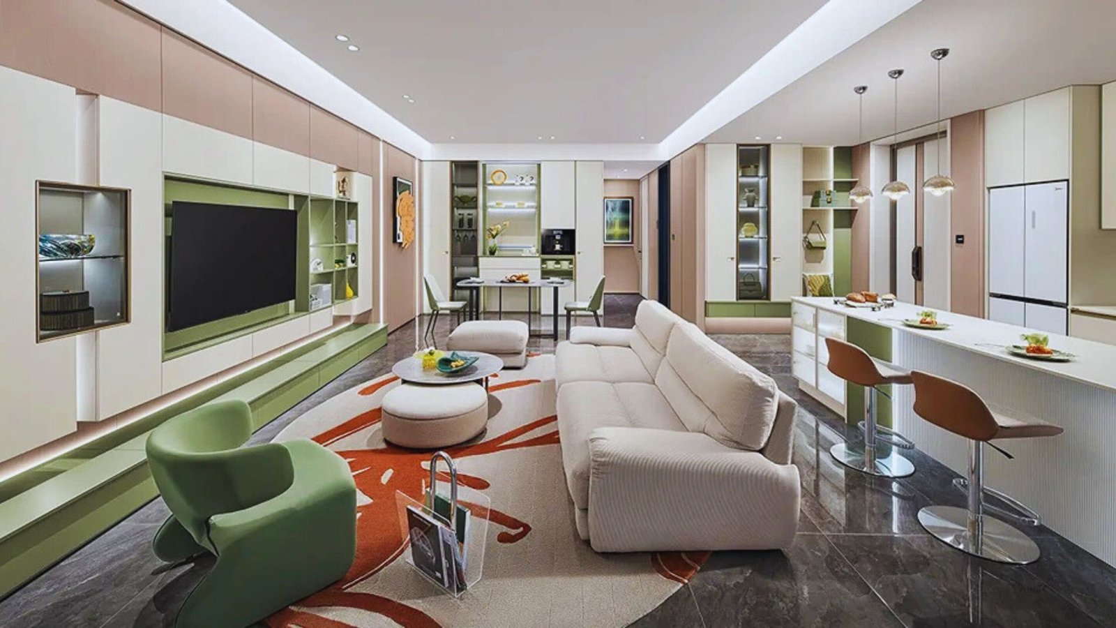 A modern living room featuring an open kitchen and dining area, showcasing contemporary furniture and decor.