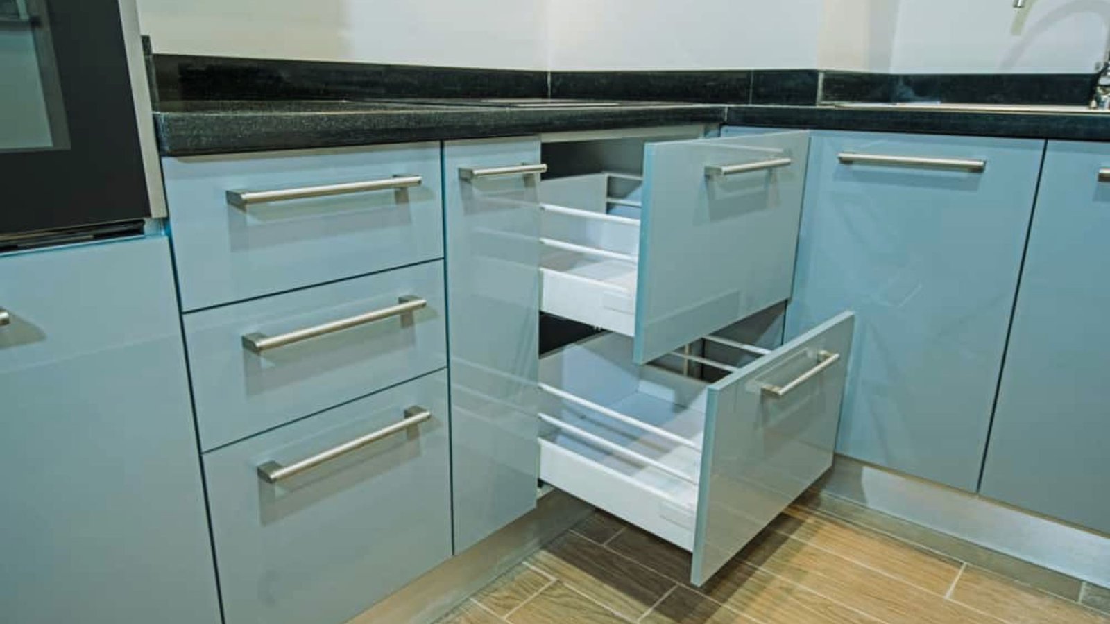 A modern kitchen featuring blue cabinets and drawers, creating a vibrant and stylish cooking space.