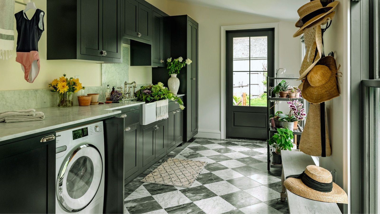  A kitchen space equipped with a washer and dryer, complemented by a hat rack for hanging hats and accessories.
