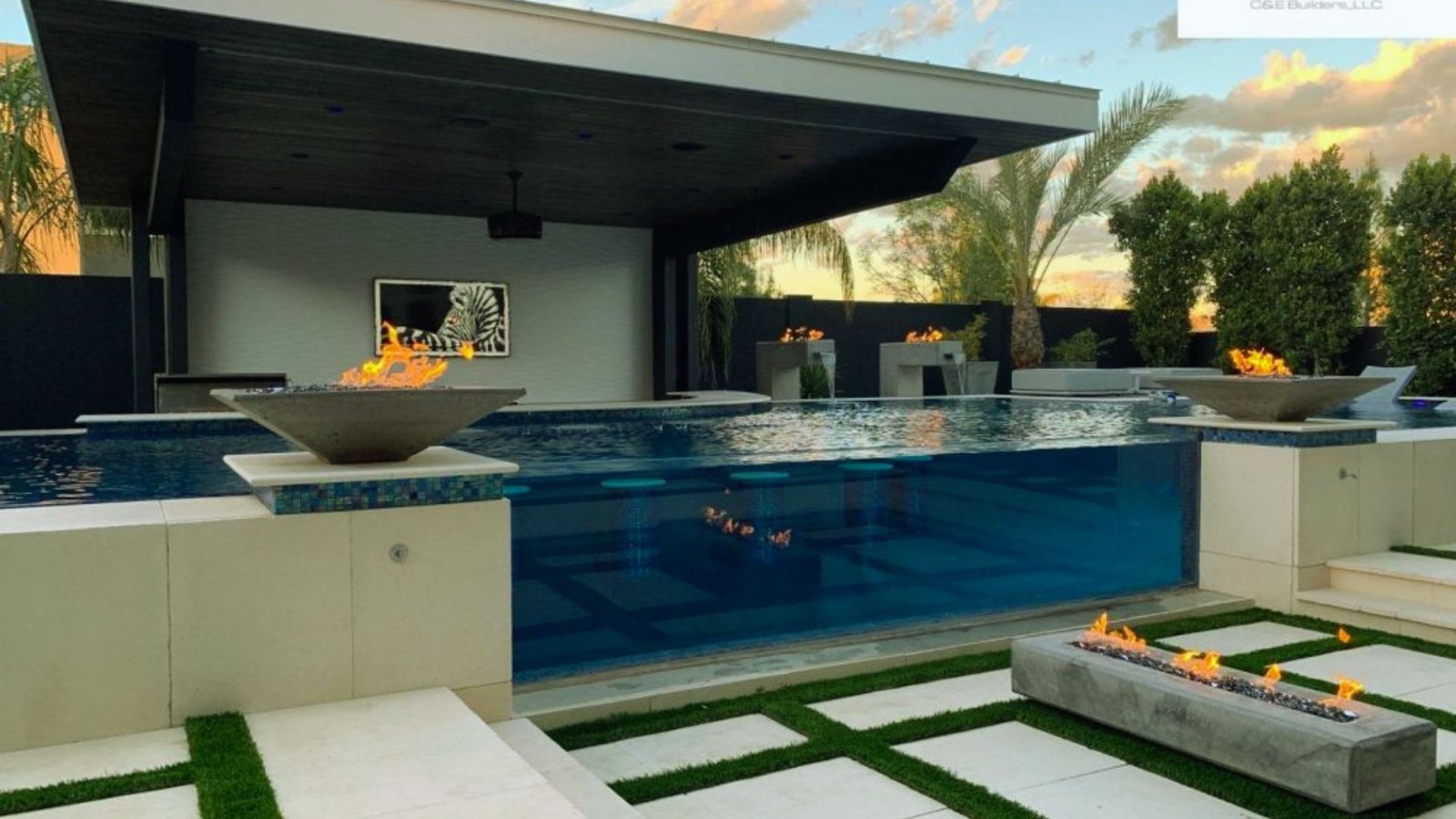 A serene pool area featuring a cozy fire pit, perfect for relaxation and evening gatherings.