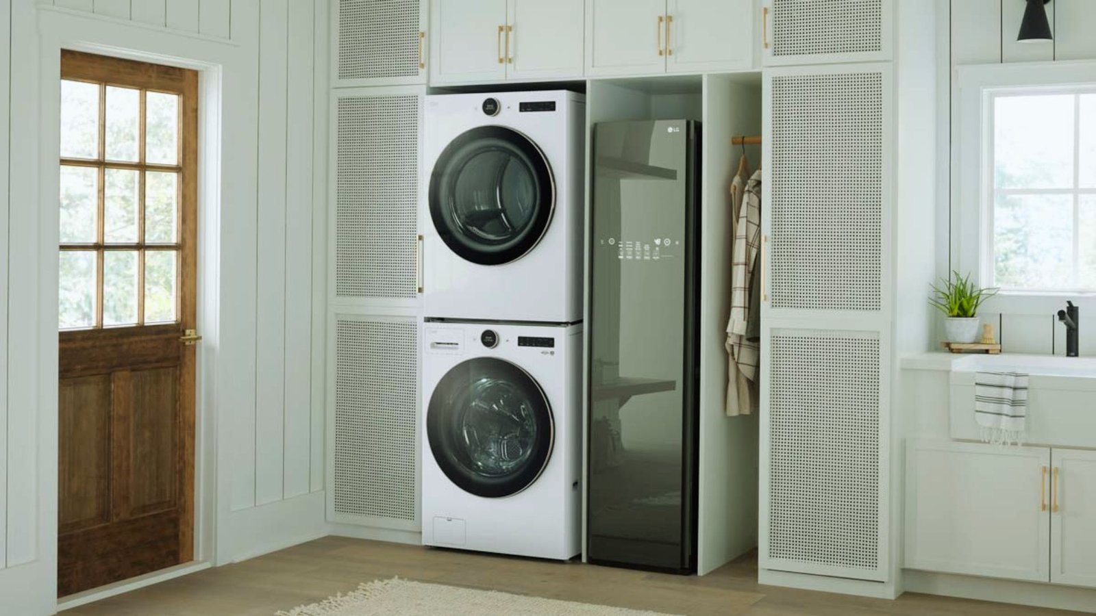 A white washer and dryer set in a compact laundry room with light-colored walls and minimal decor.