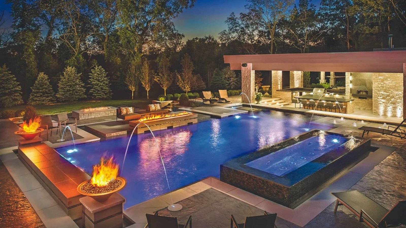 A serene pool area featuring a fire pit surrounded by comfortable lounge chairs for relaxation.