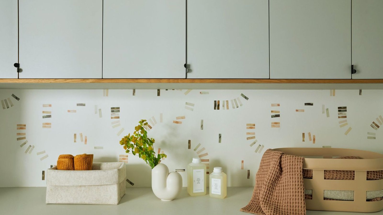  A bright white kitchen featuring white cabinets and a matching countertop, creating a clean and modern aesthetic.