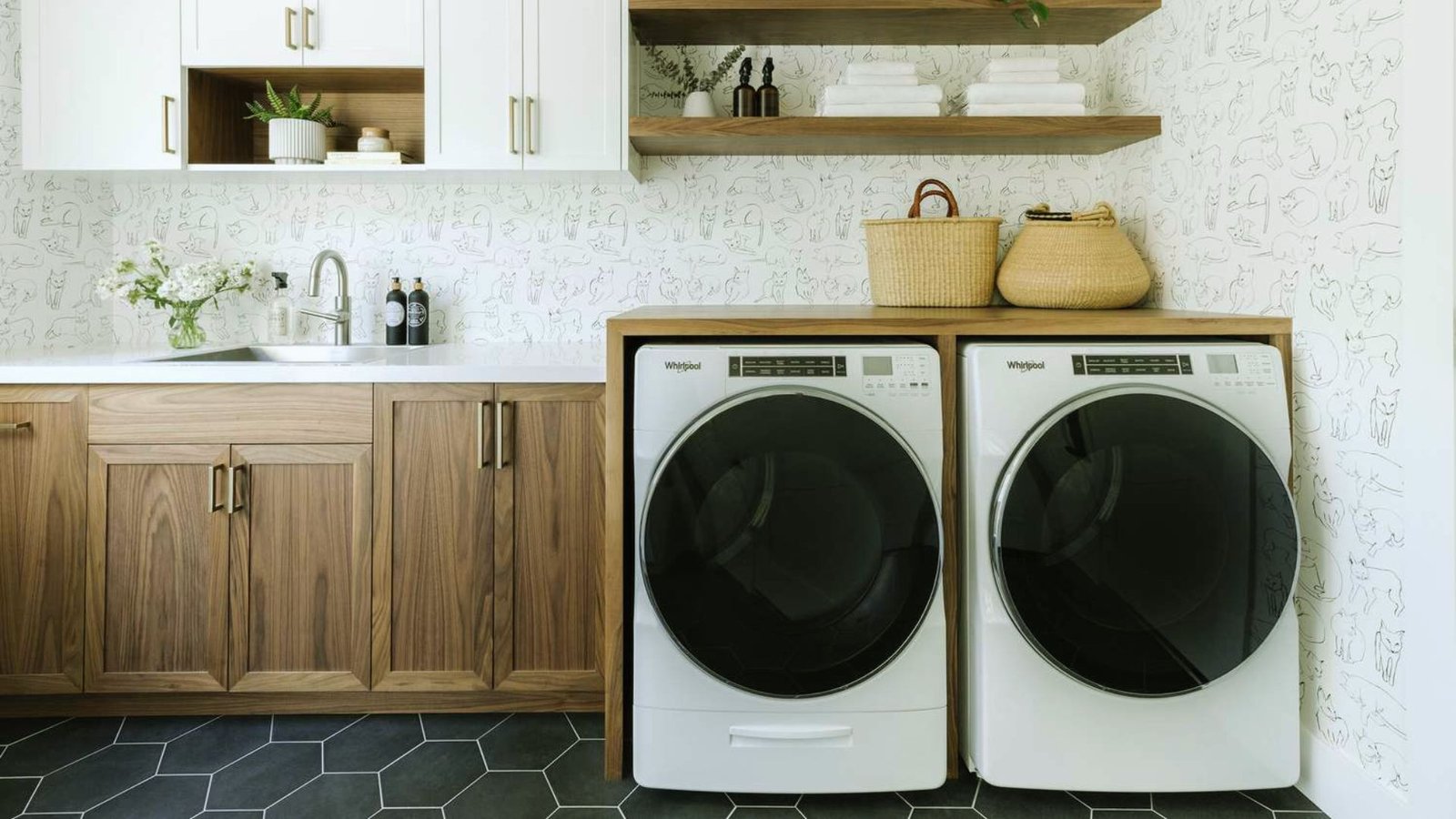 A modern laundry room featuring a sleek washer and dryer against a bright, organized backdrop.