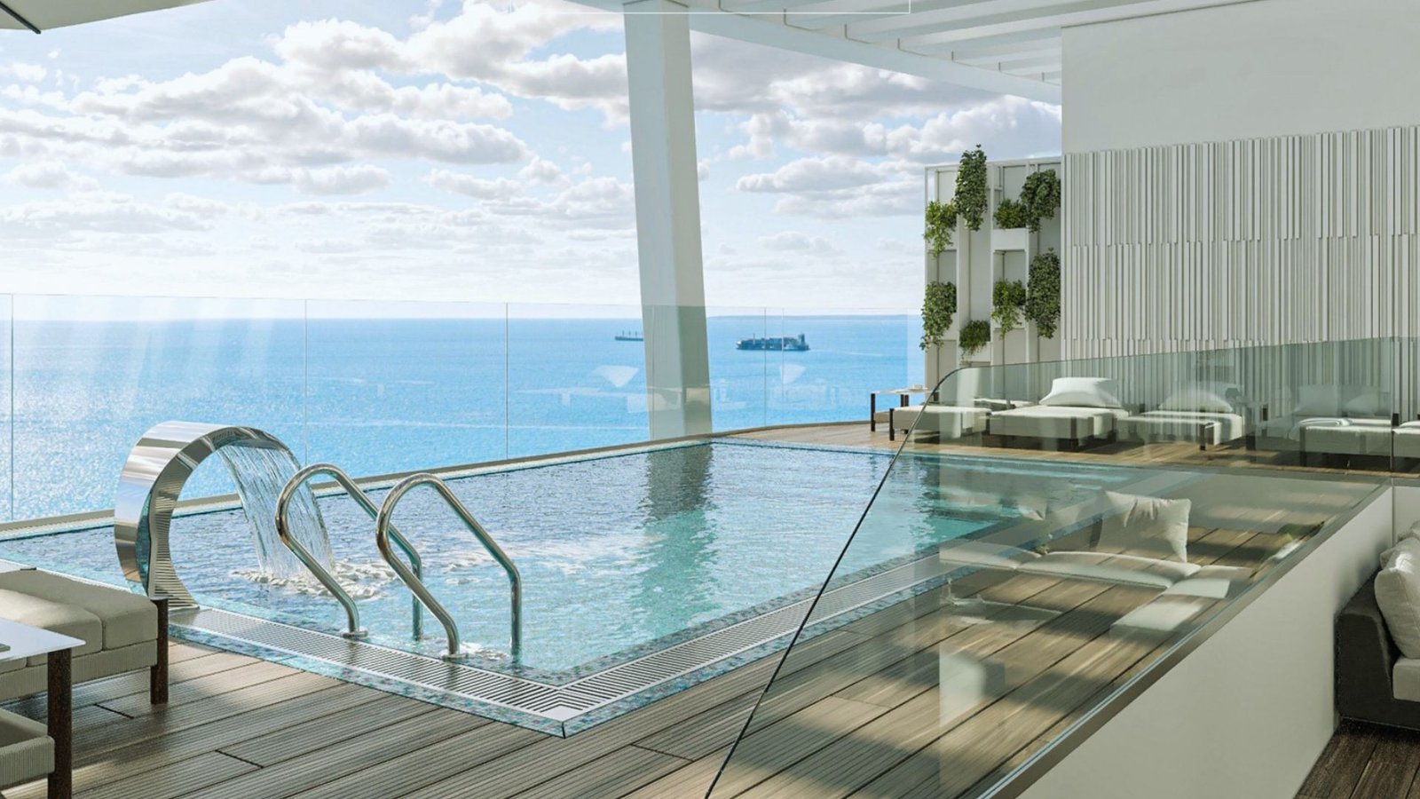 A panoramic view of the ocean from the rooftop pool at the new oceanfront hotel, showcasing clear blue waters and sky.