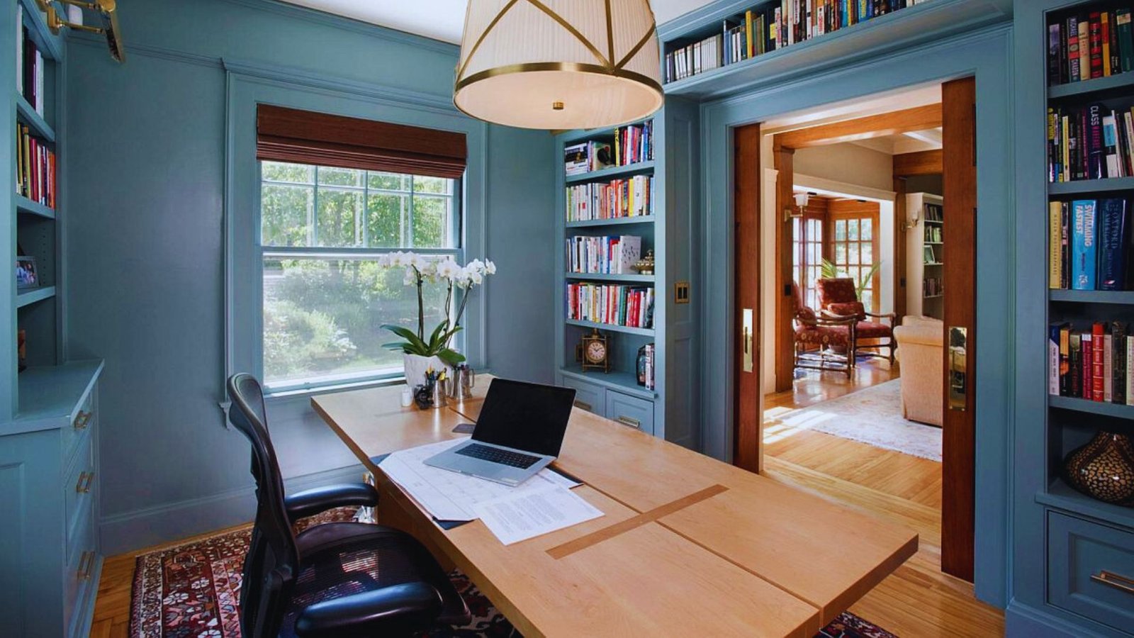 A home office featuring a desk and bookshelves filled with books, creating a cozy and organized workspace.