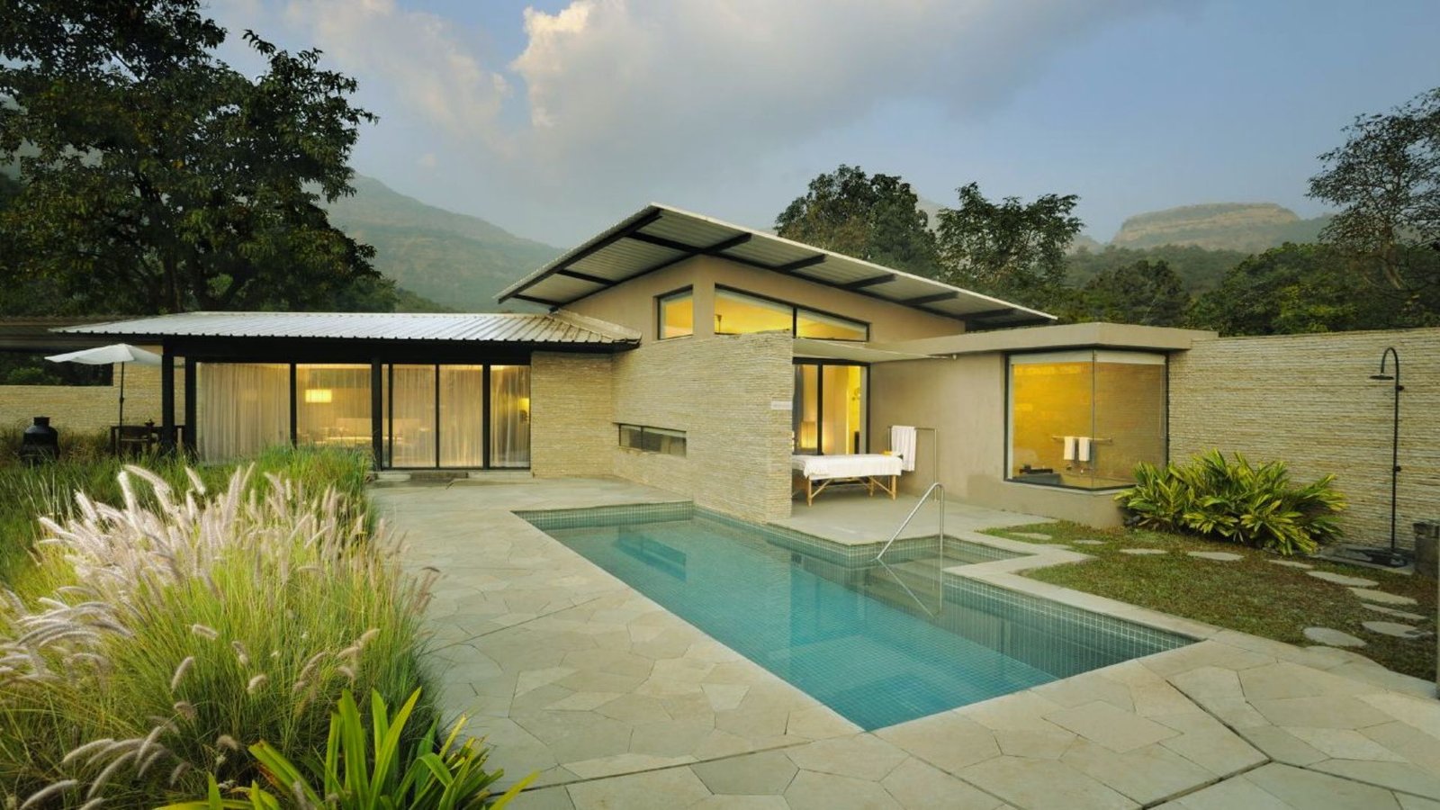 A contemporary home featuring a swimming pool and a scenic view of the mountains in the background.