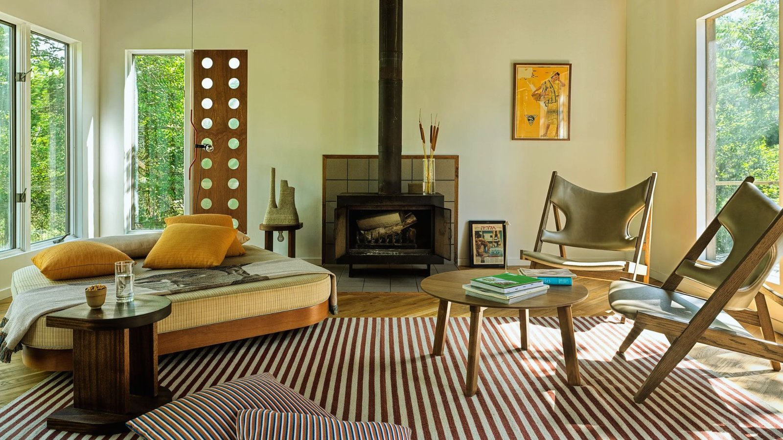 A cozy living room featuring a fireplace and a comfortable chair, creating a warm and inviting atmosphere.